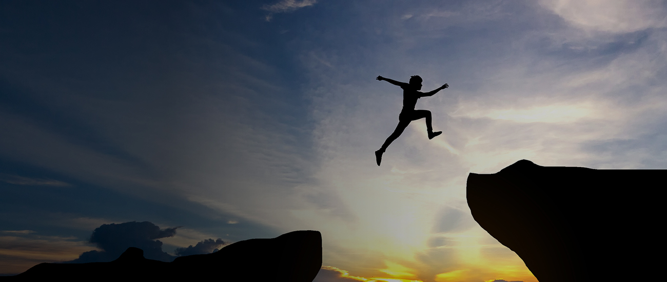 Man jump through the gap between hill - banner